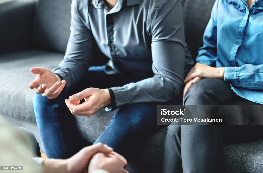 Mediator or family counsel with couple in therapy meeting. Divorce lawyer, marriage counselor, psychologist or doctor interview upset man and woman. Sad people with anxiety. Session with psychiatrist.